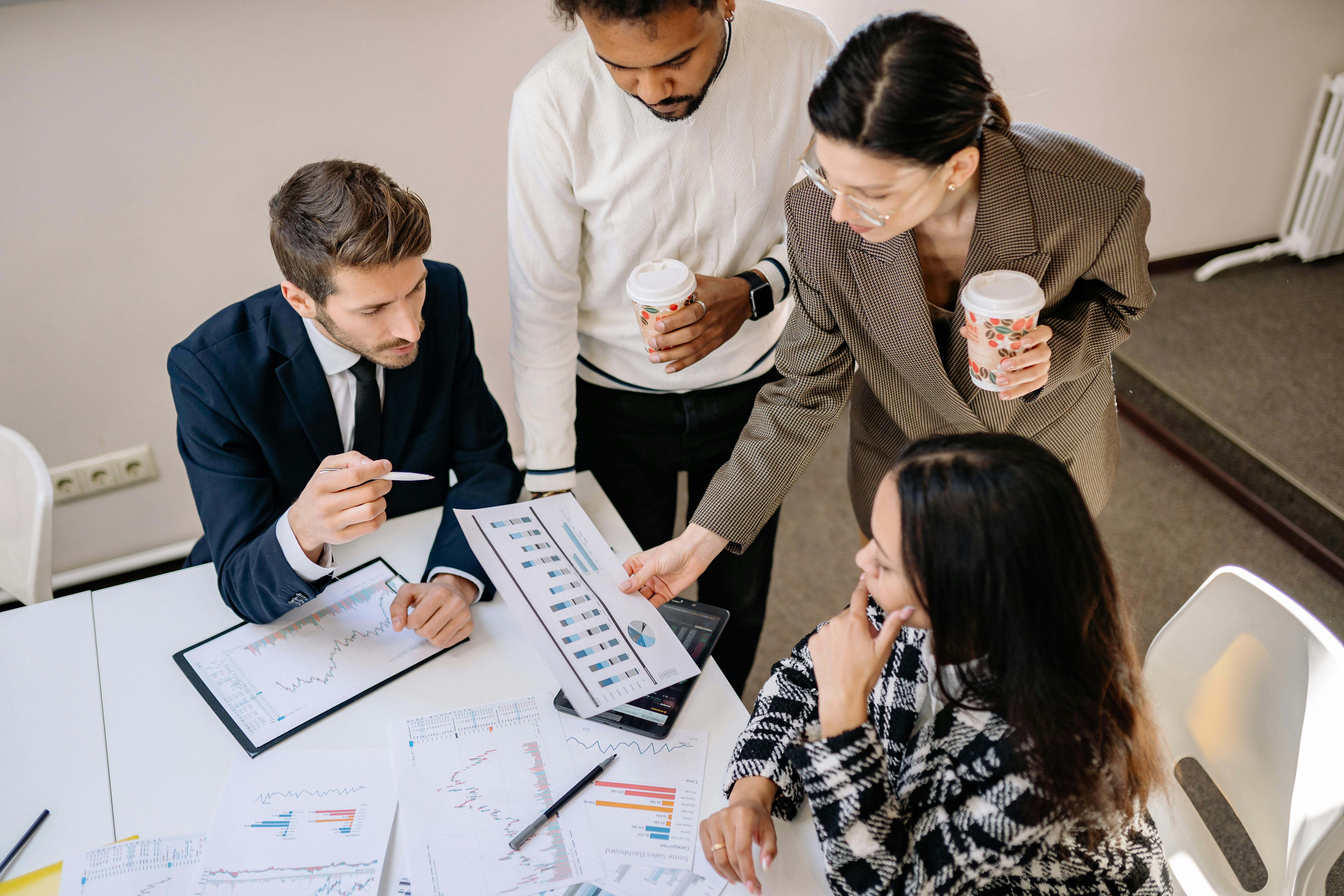 A diverse group of professionals analyzing charts and dashboards in a collaborative meeting to support data driven decision making. Photo by Yan Krukov via Pexels.