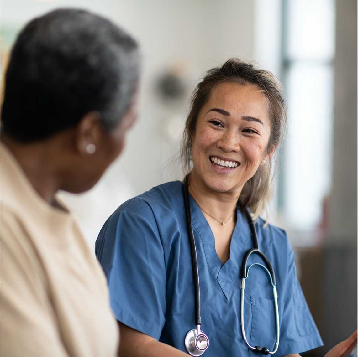 woman medical practitioner smiling at patient